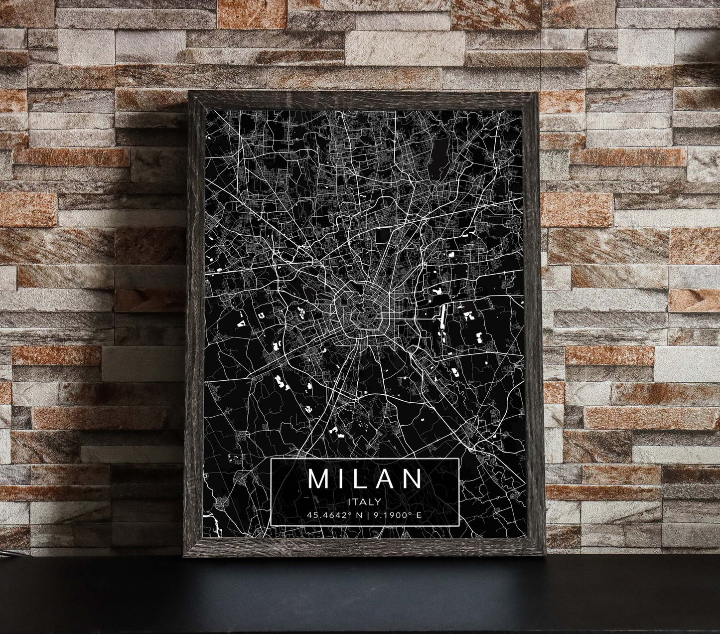 Black and white map print of Milan, Italy. The dark background highlights the city's street layout and landmarks, with coordinates listed beneath the city name