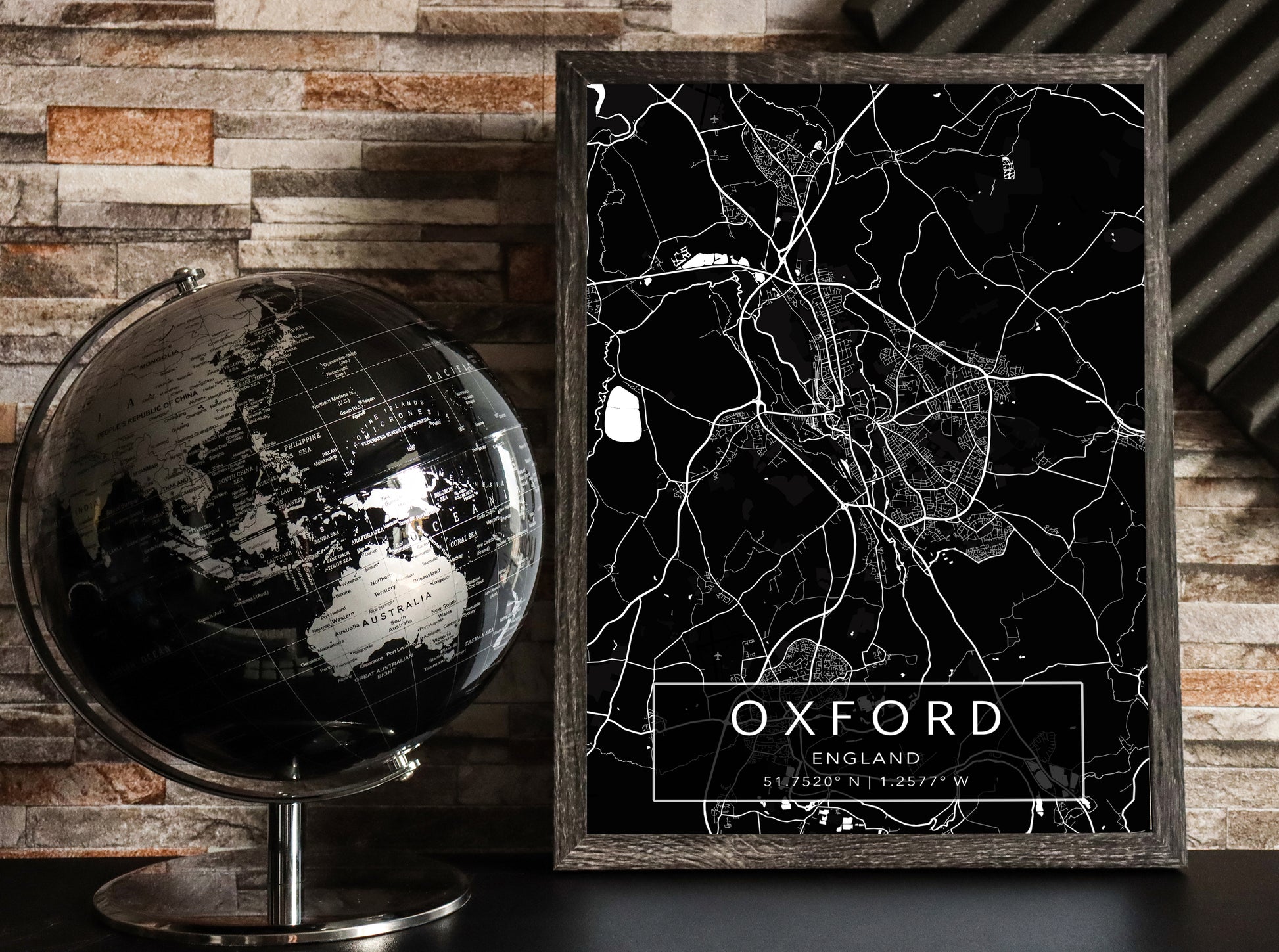 Black and white map print of Oxord, England. The dark background highlights the city's street layout and landmarks, with coordinates listed beneath the city name.