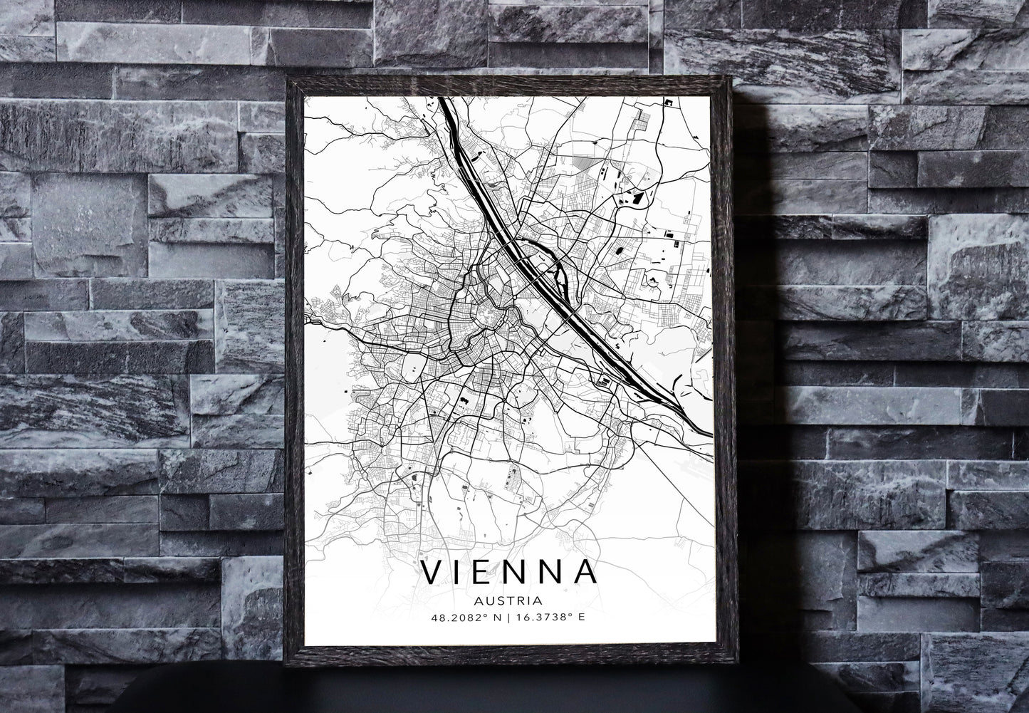 Black and white map print of Vienna, Austria. The map displays intricate city streets and geographical details, with coordinates listed beneath the city name