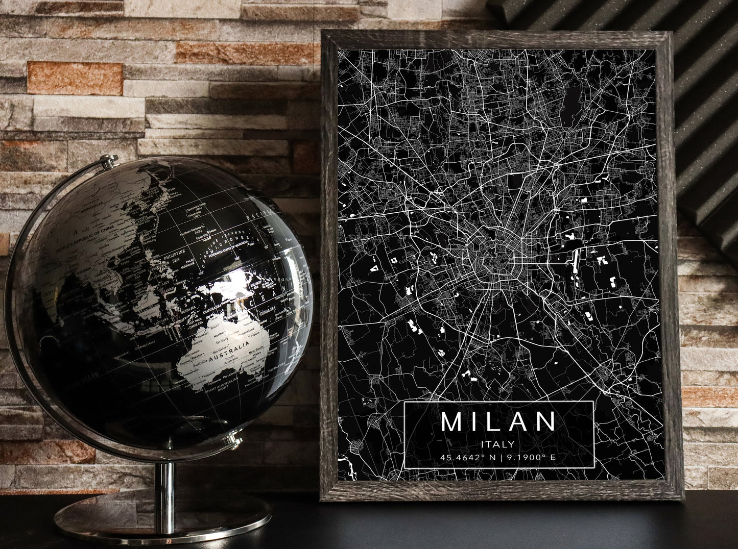 Black and white map print of Milan, Italy. The dark background highlights the city's street layout and landmarks, with coordinates listed beneath the city name