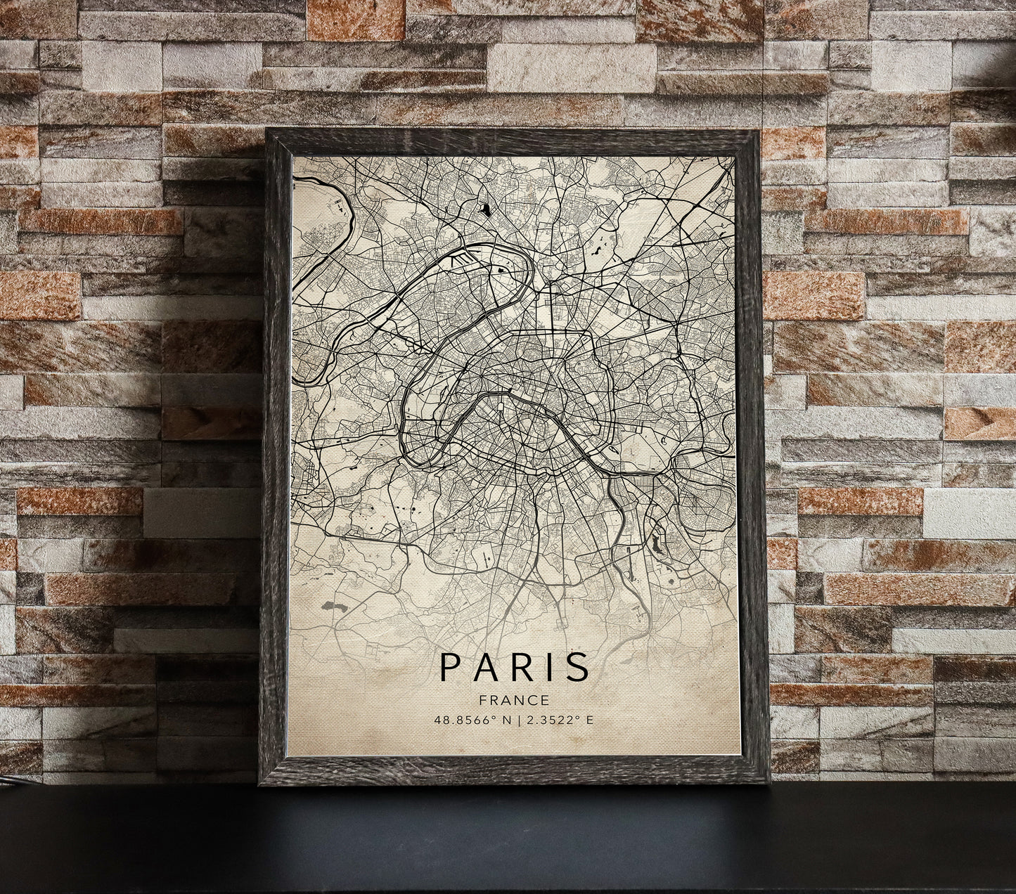 Vintage rustic map print of Paris, France. The map displays intricate city streets and geographical details, with coordinates listed beneath the city name.